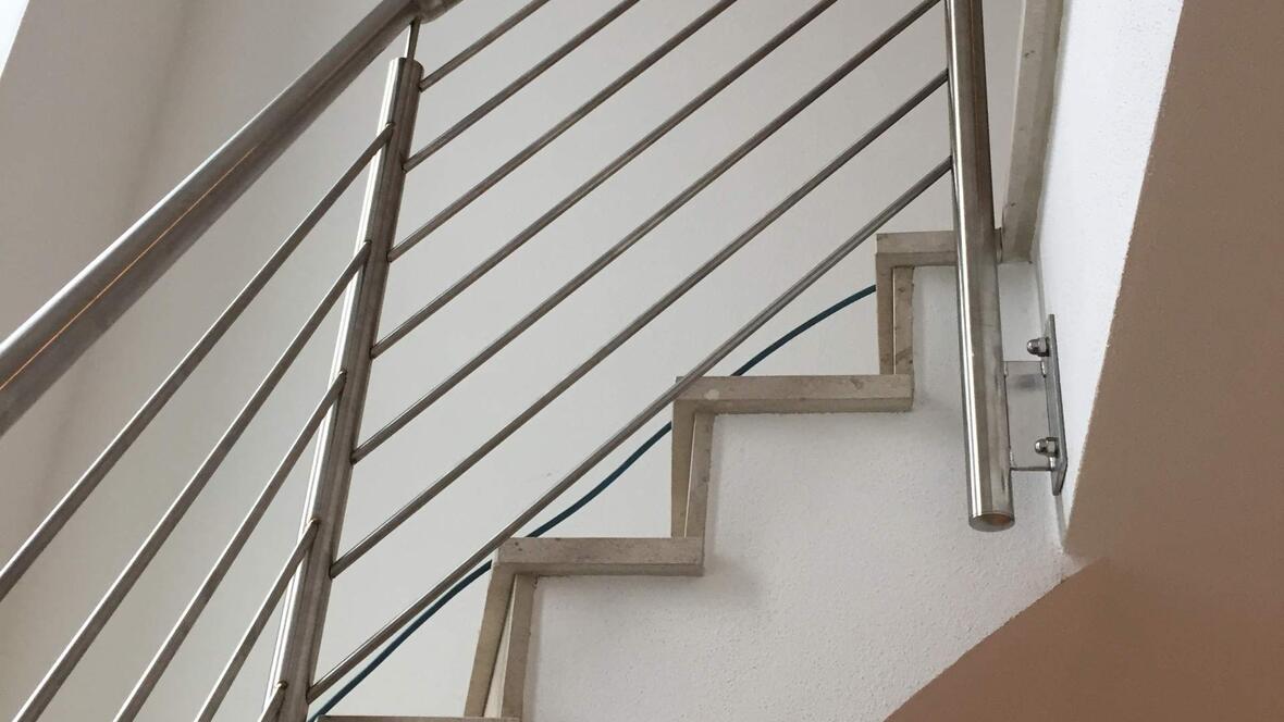 weisser-treppenaufgang-mit-silbernen-gelaender